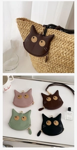 Detail showing various colors of PU leather cat-shaped coin purses with neck straps