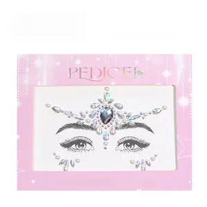 Close-up of face gems with AB crystals and pearls on star-patterned backing paper