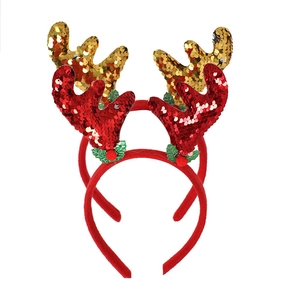 Detail of Christmas headband with red and gold sequin reindeer antlers and green leaf accents