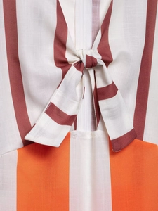 Detailed view of the striped pattern fabric and decorative bow tie on a summer dress