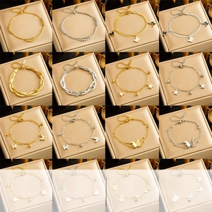Variety collection of gold and silver chain bracelets with butterfly and star charms
