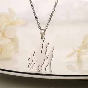Detail view of a silver family pendant showing parents and children holding hands