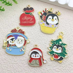 Detailed view of five colorful Christmas penguin alloy pendants for DIY jewelry crafts