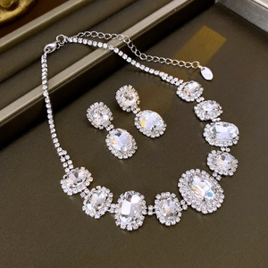 Elegant silver-toned jewelry set with oval crystal necklace and matching earrings