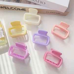 Macro shot of six square matte hair claws in a colorful macaron palette assortment