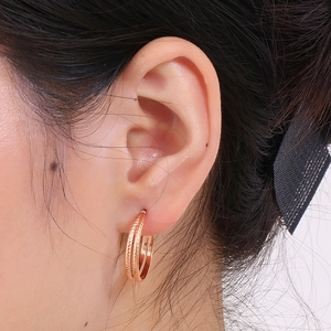Minimalist C-shaped double hoop earrings in rose gold finish with textured details