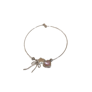Silver bracelet featuring zircon pink heart pendant, bow charm and metallic star beads