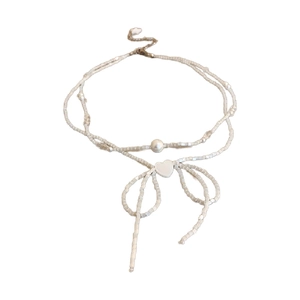 Elegant white beaded choker necklace featuring a pearl bow and heart pendant for women