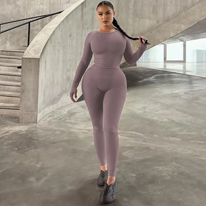 Detail of slim fit dusty pink yoga set showing high-elastic knitted fabric and stitching