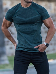 Close-up of men's dark green fitness t-shirt showing breathable mesh panels and seams
