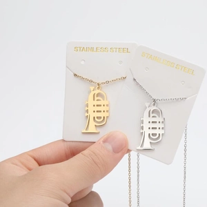 Detailed close-up of gold and silver trumpet flower pendants on stainless steel chains