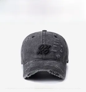 Front view of washed dark grey denim baseball cap with vintage distressed ripped details