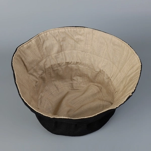 Detail of linen sun hat showing dual-color interior lining and breathable fabric texture