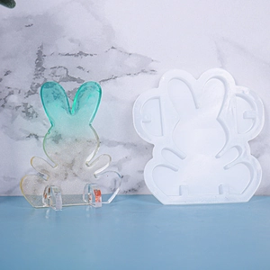 Detail showing white silicone rabbit mold and finished glitter resin bunny figurine