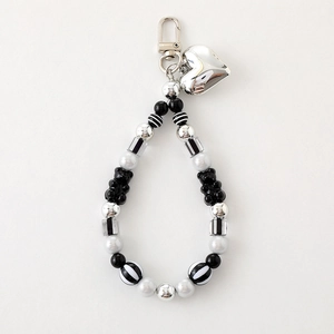 Handmade beaded keychain with white pearls, black bear charm, and silver heart pendant