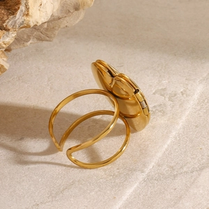 Detail view of a gold heart-shaped open ring with dual-layer adjustable band design