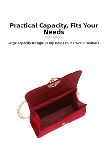 Detail view of the spacious red velvet handbag interior with gold clasp and pearl strap
