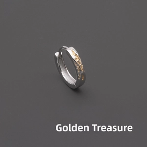 Detail showing the irregular molten gold texture and silver finish of the huggie earring