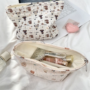 Detailed interior of quilted cartoon bear makeup bag showing large storage capacity