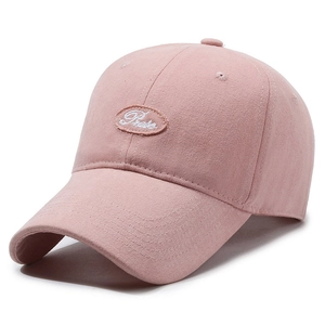 Pink cotton baseball cap with embroidered patch and curved brim in 45-degree side view