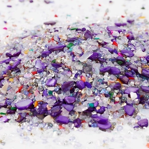 Detailed macro shot of 2-8mm purple mixed glass chips and pearls for DIY crafts