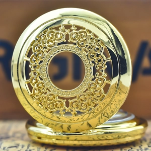 Macro shot of vintage gold quartz pocket watch with intricate hollow flower engraving