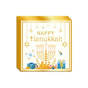 Detail of Hanukkah square decorative cards featuring golden foil dreidel and menorah icons