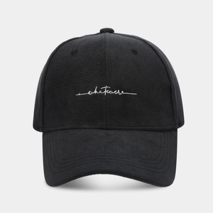 Close-up of premium black suede baseball cap with white artistic whatever embroidery