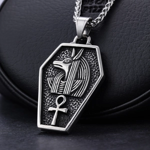 Macro shot of silver Anubis pendant with Ankh symbol on vintage stainless steel chain