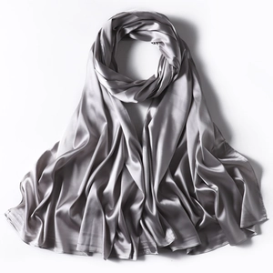 Detail shot of smooth grey satin scarf showing elegant silk texture and soft drape