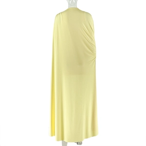 Detail view of the back pleats and ruched fabric on this light yellow knit maxi dress