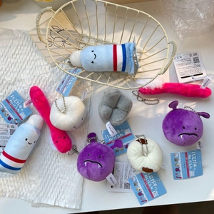 Macro shot of cute plush dental keychains featuring toothpaste and tooth characters