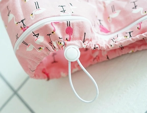 Detail of pink flamingo pet cooling collar showing the zipper and adjustable drawstring