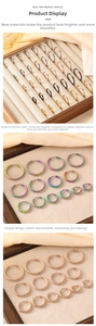 Close-up of stainless steel hoop earrings in various sizes and metallic finishes