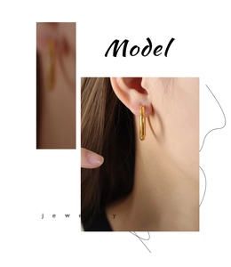 Close-up of model wearing minimalist 18k gold plated chunky hoop earrings in a retro style