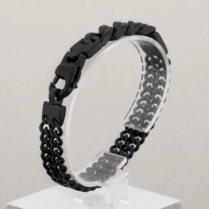 Detail of matte black stainless steel double-row link bracelet with industrial buckle