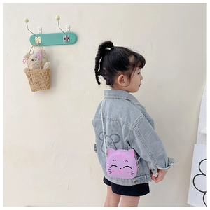 Detailed back view of a cute purple cat cartoon shoulder bag for girls in a lifestyle setting