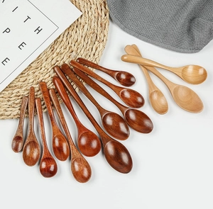 Detailed overhead view of assorted Japanese-style wooden spoons on a textured mat