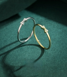 Detailed macro view of 925 sterling silver bow rings with micro-pave diamond settings
