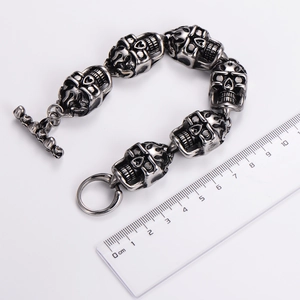 Detailed view of vintage skull link bracelet in silver finish with ruler for size reference