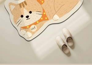 Detail of a cartoon orange cat shaped bathroom mat with cat text on a light floor