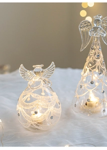 Detail of two luminous glass angels with glitter accents and glowing LED candle lights