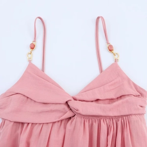 Pink midi dress with knot twist detail and gold beaded straps in textured fabric