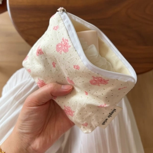 Elegant floral cotton mini pouch for coins and lipstick shown held by a hand