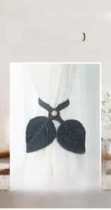 Detailed view of dark grey handmade macrame curtain tieback with double leaf design