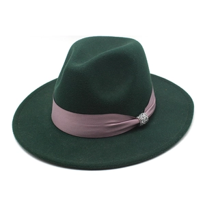 Detail of dark green wool fedora hat with lavender satin ribbon and crystal ball ornament