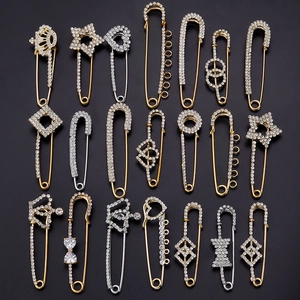 Variety of crystal zircon safety pins and U-shaped brooches in gold and silver finish