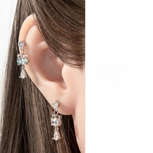 Detail of silver cat-shaped earrings with blue oval zircon and teardrop pendants