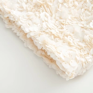 Detailed macro view of white shimmering sequins sewn on fabric for casual fashion mini skirt