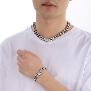 Polished silver stainless steel Cuban chain necklace and bracelet set for men on model